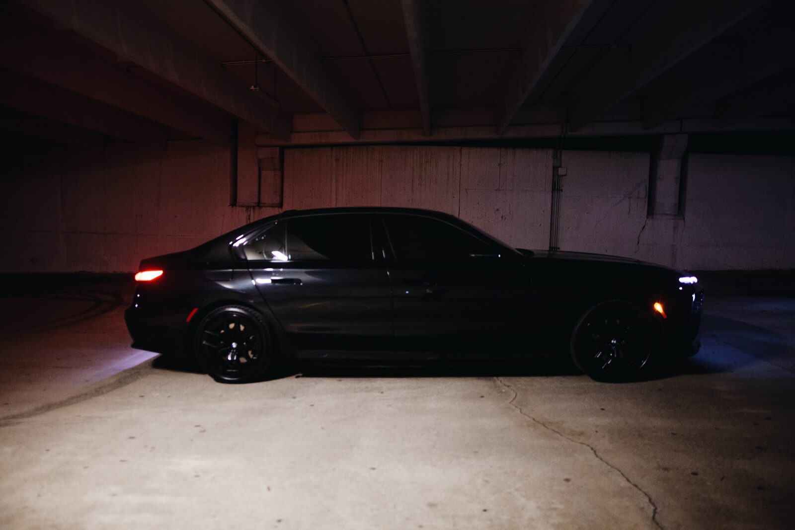 Fleet of luxury black vehicles at night